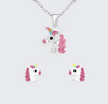 Unicorn-shaped necklace and earrings on a light gray background
