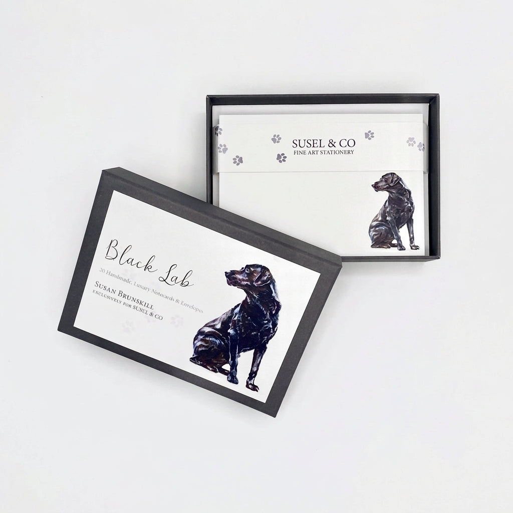 Two framed cards or prints with black dog illustrations and the text 'Black Lab' and 'SUSEL & CO' are displayed on a white surface against a white wall.