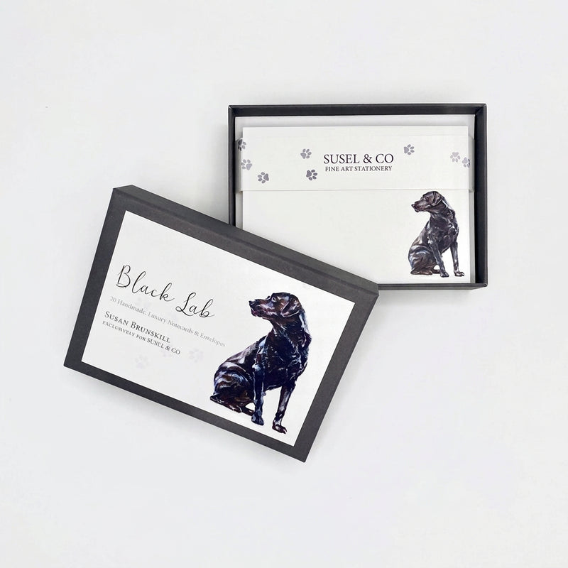 Two framed cards or prints with black dog illustrations and the text 'Black Lab' and 'SUSEL & CO' are displayed on a white surface against a white wall.