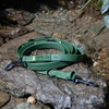 PVC Green dog leash with metal clips on a rocky watery surface