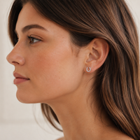 Girl wearing silver sparkly horse shoe earring