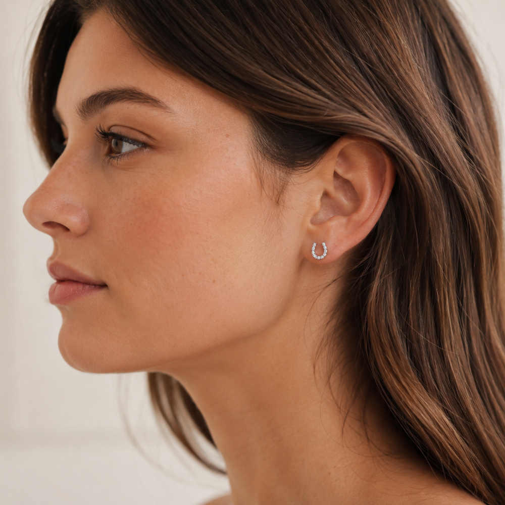 Girl wearing silver sparkly horse shoe earring
