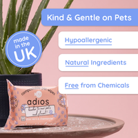Adios compostable pet wipes packaging with plant and text highlighting product features on a pink background